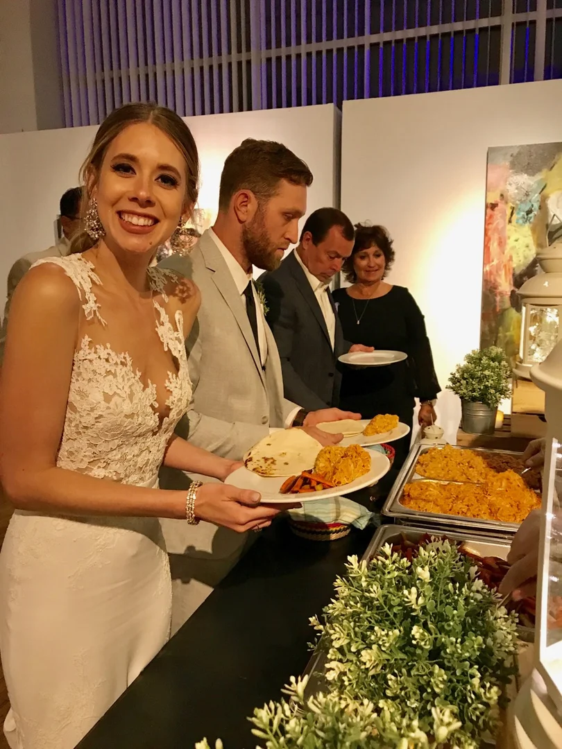 A bride enjoying food at an event photographed on XIM's website