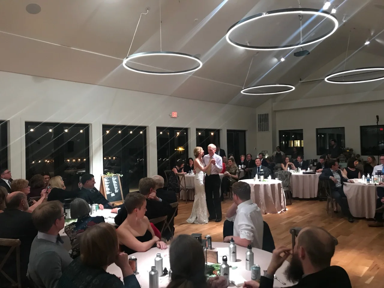 Guests gathered at a wedding reception from XIM's website