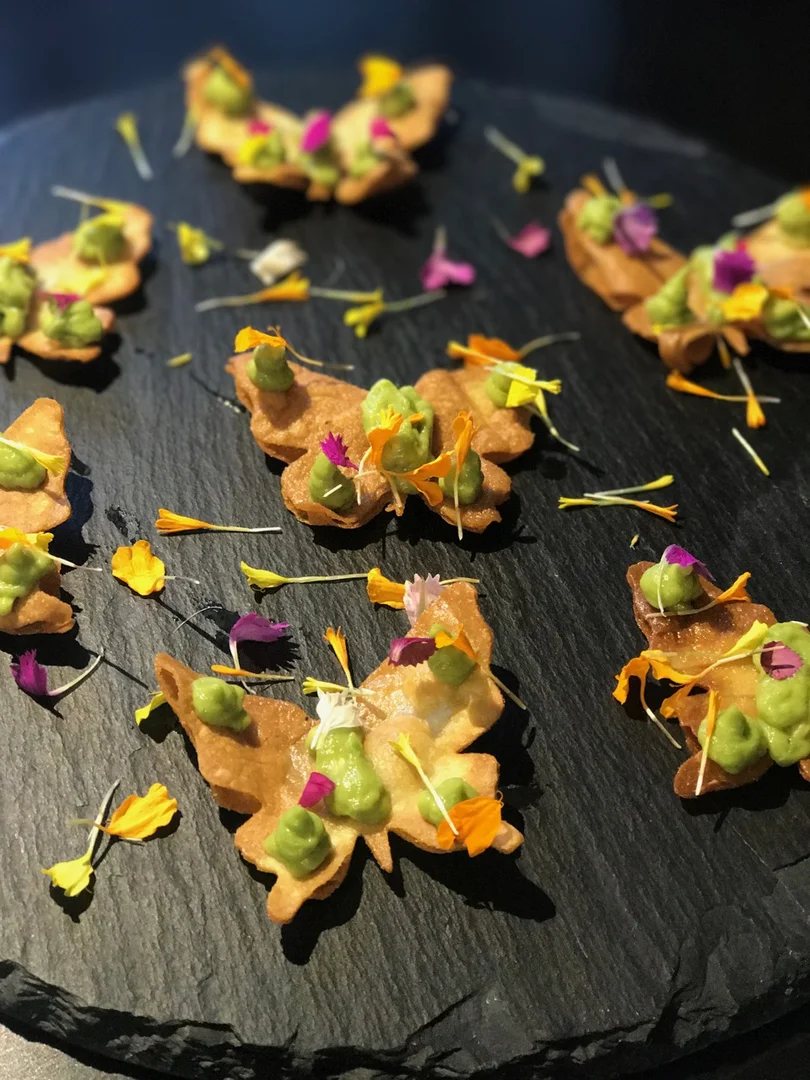 Colorful XIM hors d'oeuvres finished with herbs and edible petals